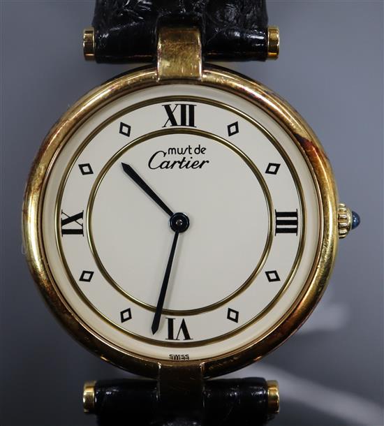 A ladys silver gilt Must de Cartier quartz wrist watch, with deployment clasp, in Cartier box.